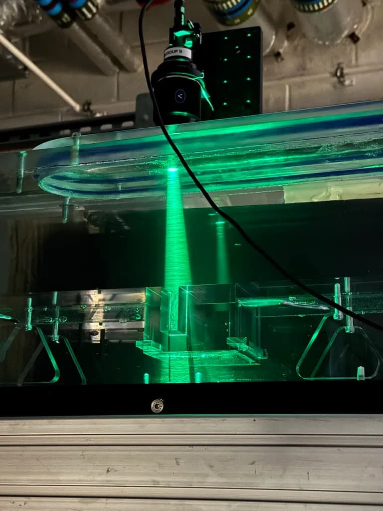 An experimental rig with a camera above a green laser sheet